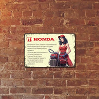 Young beautiful woman with internal combustion engine Honda gasoline metal plate